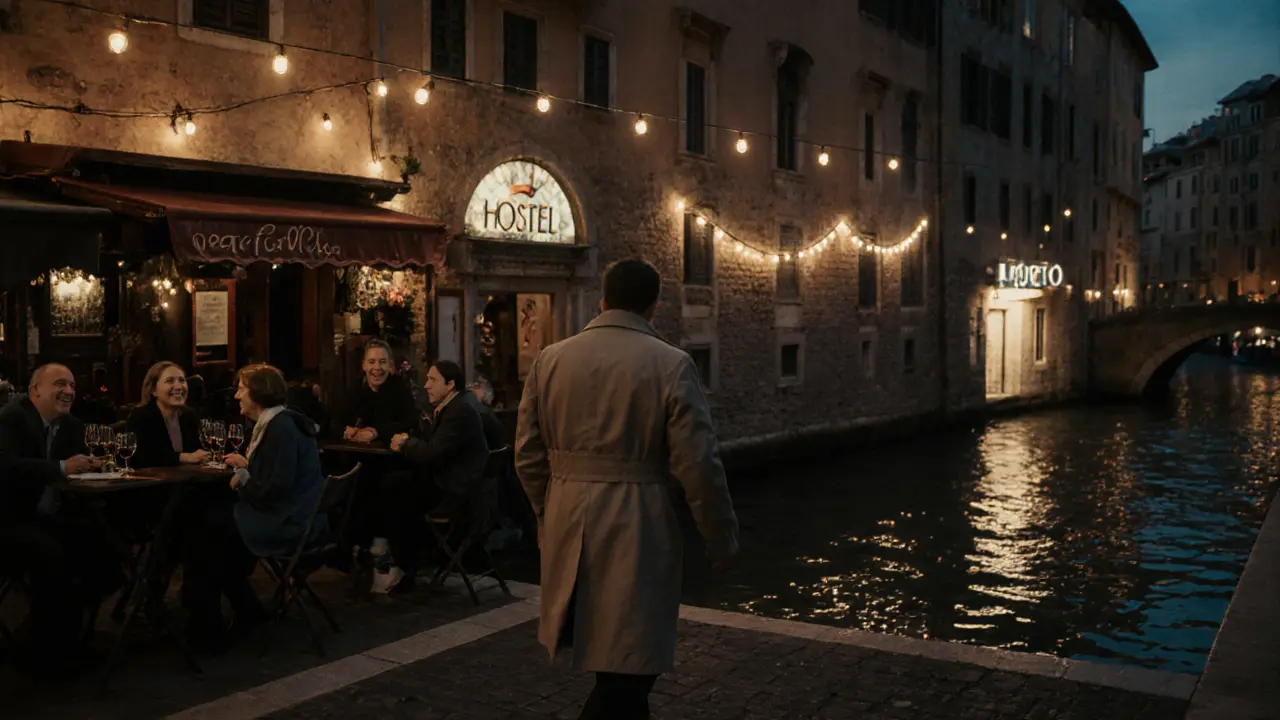 A lone person walking along Milan&#039;s Navigli canal at dusk, near a warm-lit wine bar and discreet hotel entrance.
