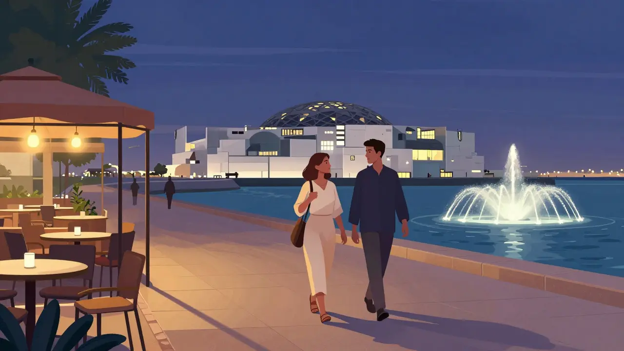 Two people walking along the Corniche at dusk, shadows long, the Louvre Abu Dhabi visible in the distance.