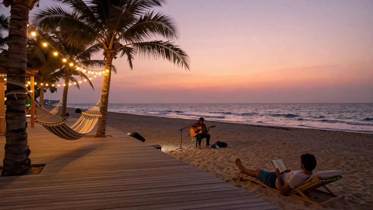 A quiet beach scene at Beachcomber with hammocks, string lights, and an acoustic musician playing as the sky turns pink.