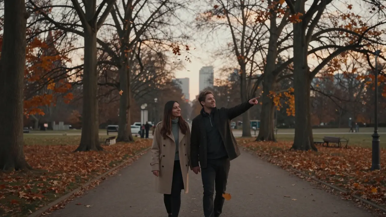 A couple walking peacefully through Tiergarten at sunset, leaves falling around them in golden light.