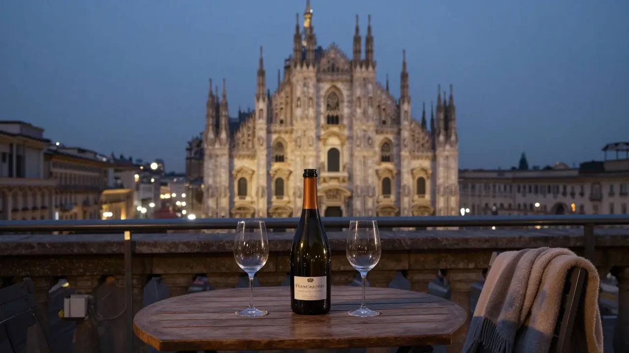 A rooftop terrace in Milan overlooks the Duomo at dusk, with a shared bottle of wine and empty glasses.